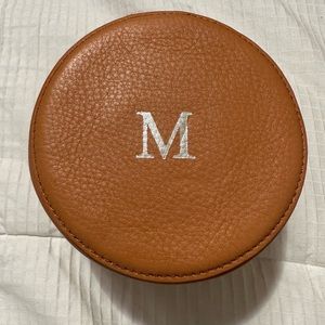 Mark and Graham Zoe leather round tech case, foil embossed with letter “M”